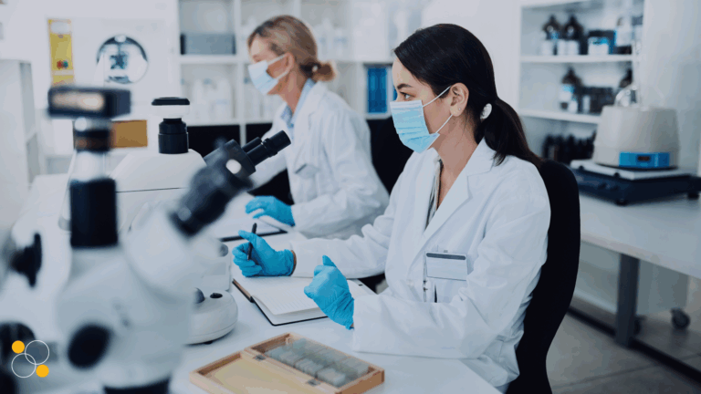 Pharmaceutical professionals working in a laboratory, illustrating modern GxP compliance and digital systems in regulated environments.